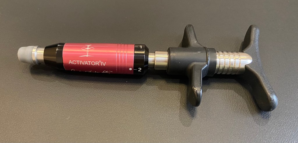 Red chiropractic activator tool